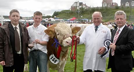 The Northern Bank Simmental Male of the Year Award was won by Derrycallaghan Alan, owned by Harold Stubbs, and grandson, Alan Burleigh. Adding their congratulations are Rodney Brown and Billy O'Malley, agribusiness managers, Northern Bank, Enniskillen.